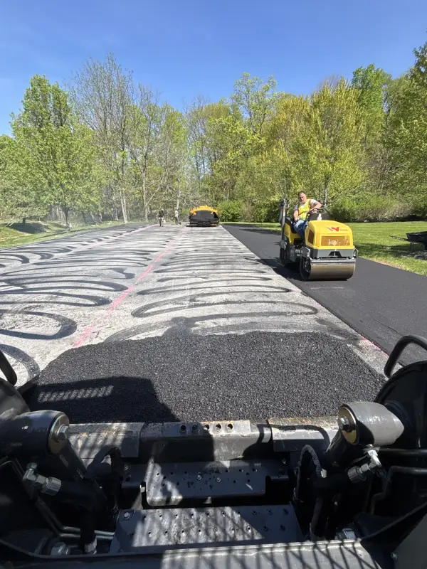 Asphalt being laid on a parking lot.